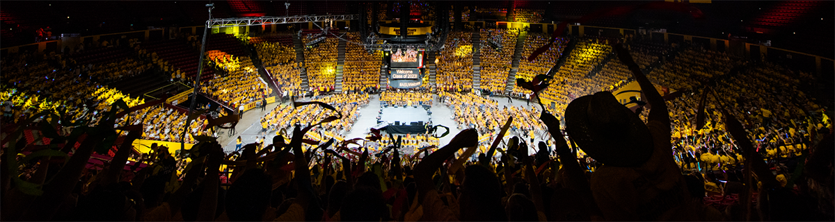 students gathered in large arena in festive mood