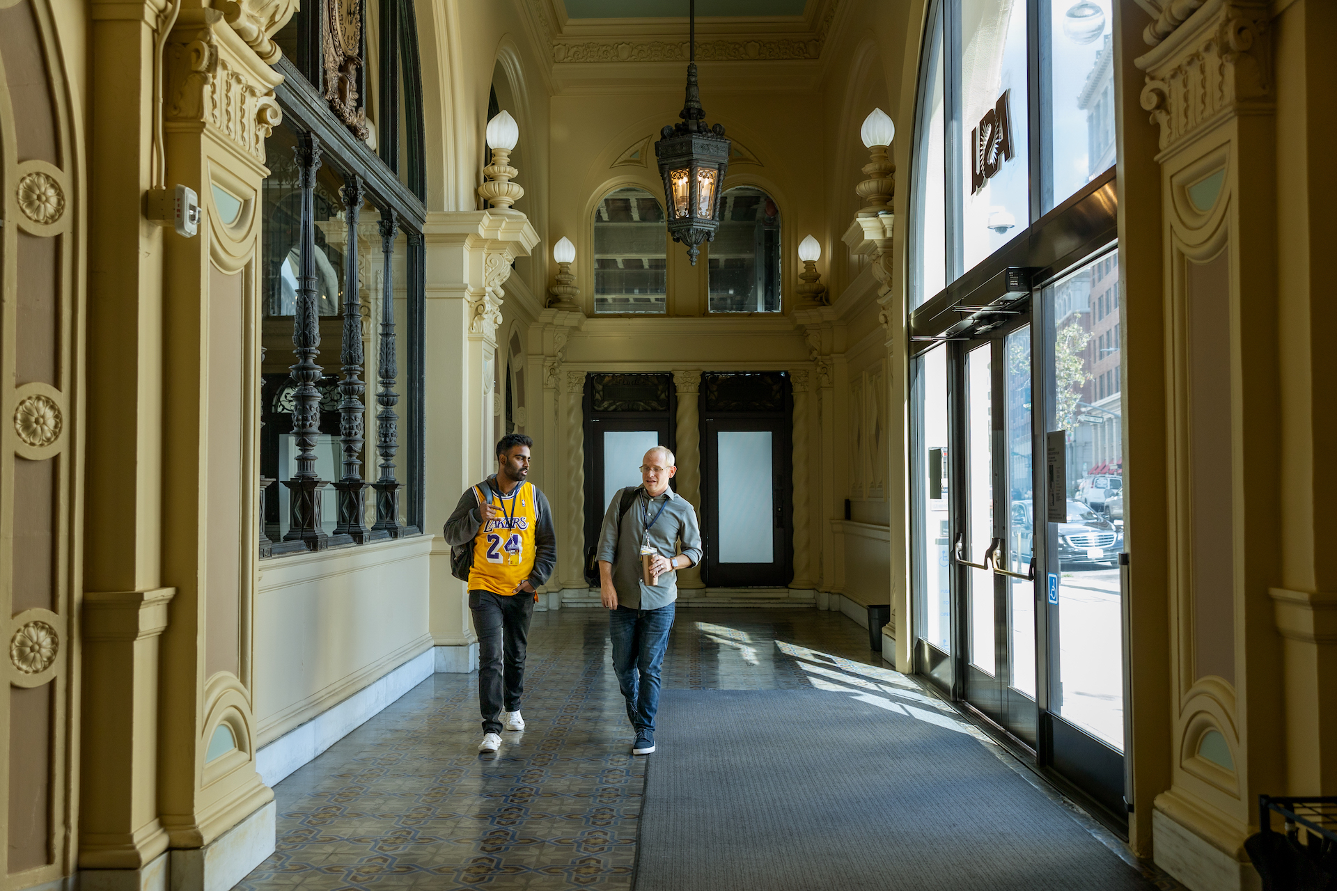 California College of ASU student and faculty in lobby.